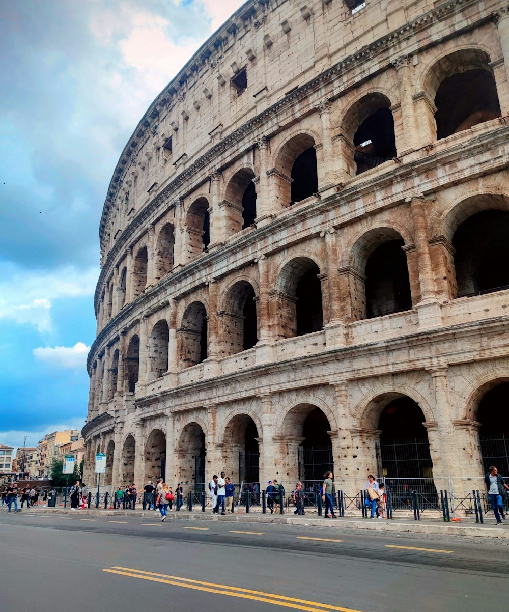 a group of people standing in front of a large building