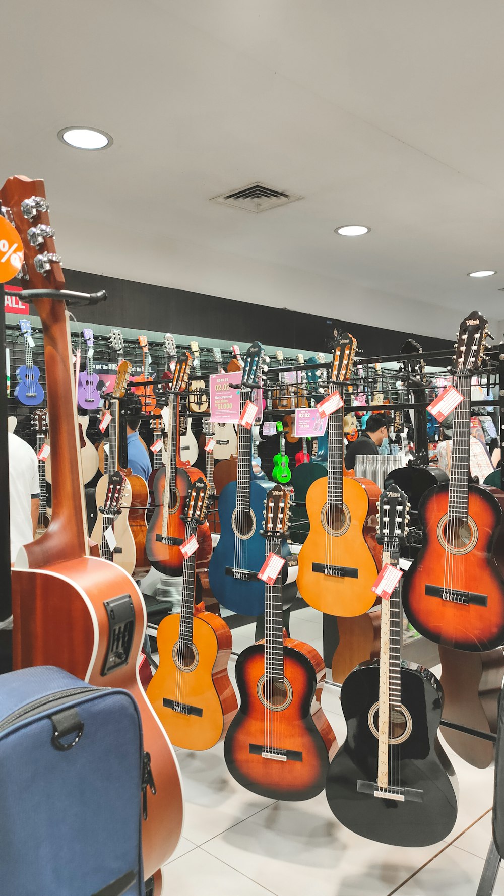 a room filled with lots of guitars on display