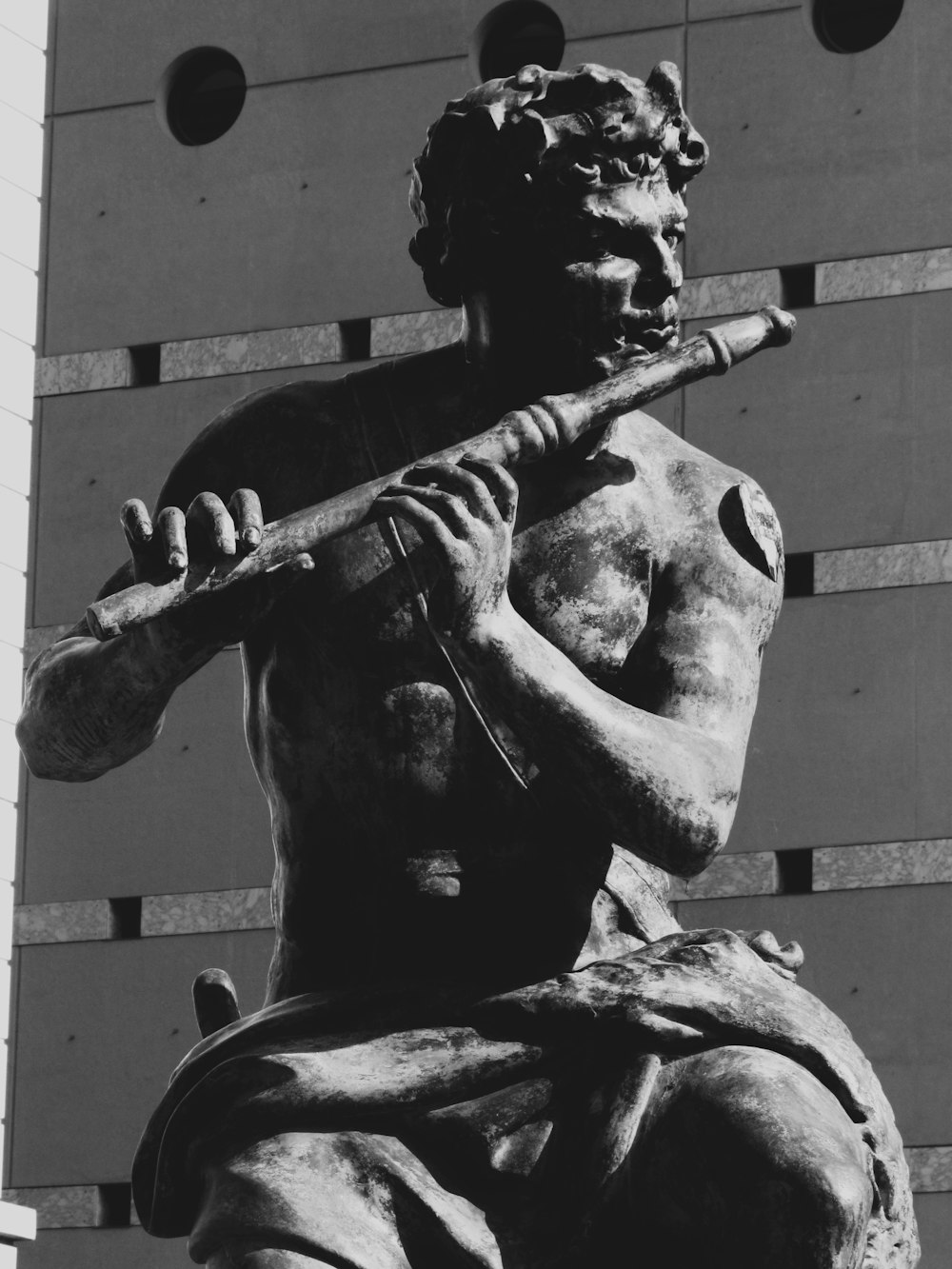 a statue of a man holding a baseball bat