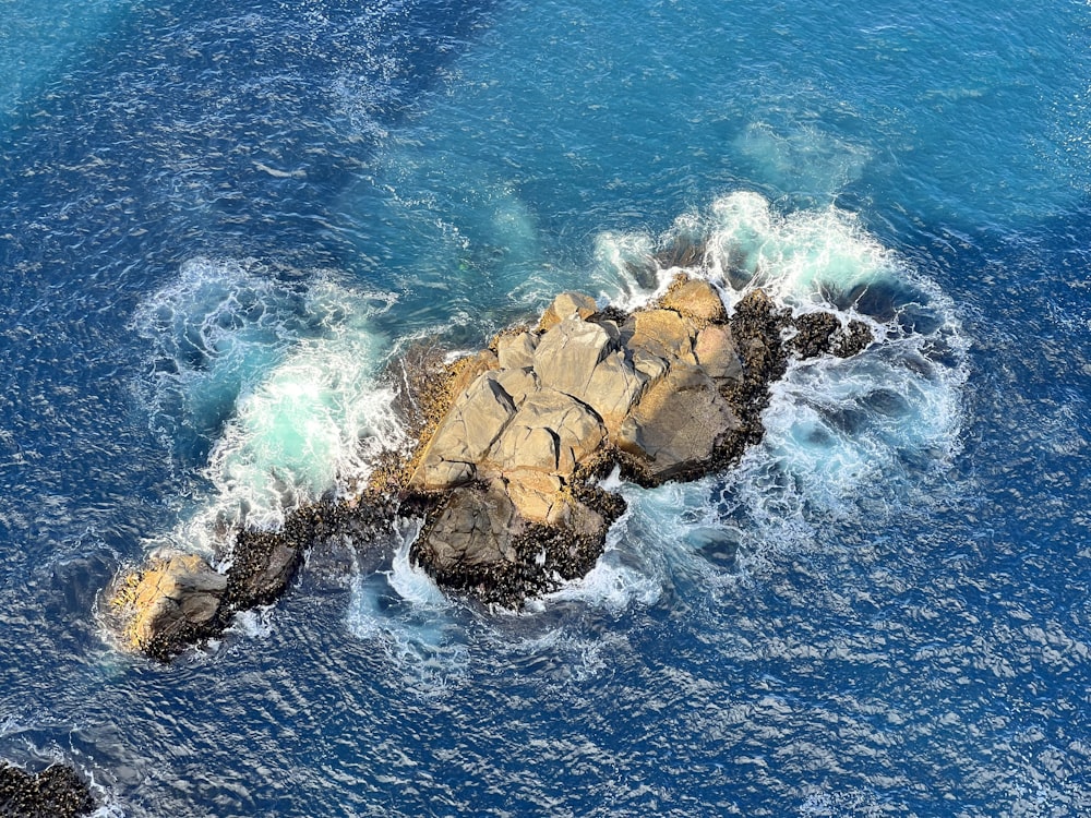 a rock outcropping in the middle of the ocean