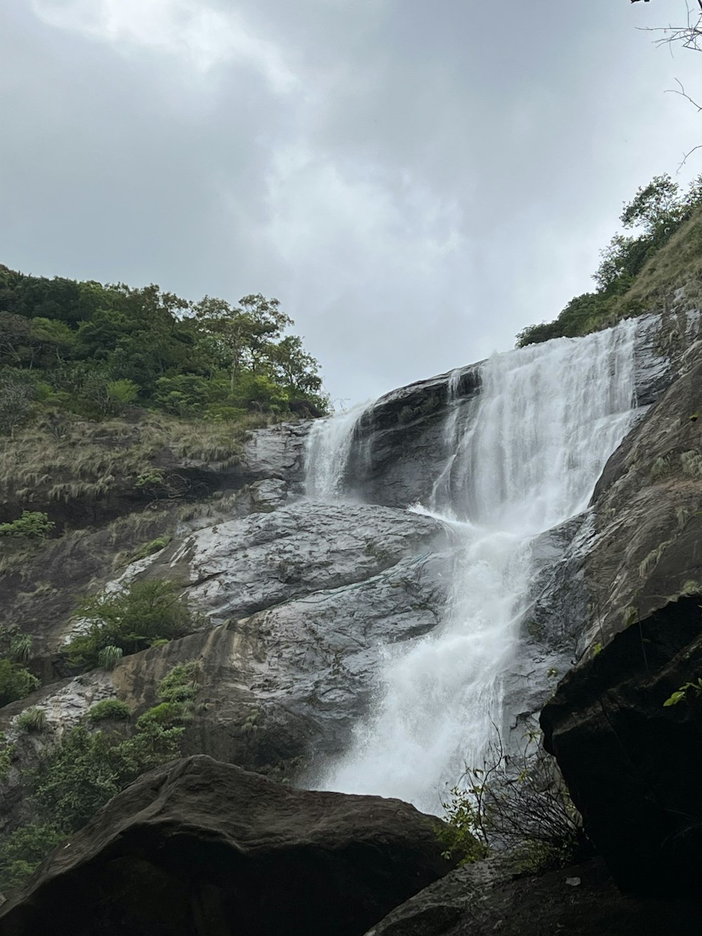 a large waterfall with water cascading down it's side