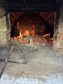 A traditional kiln with glowing embers, ready for firing pottery.