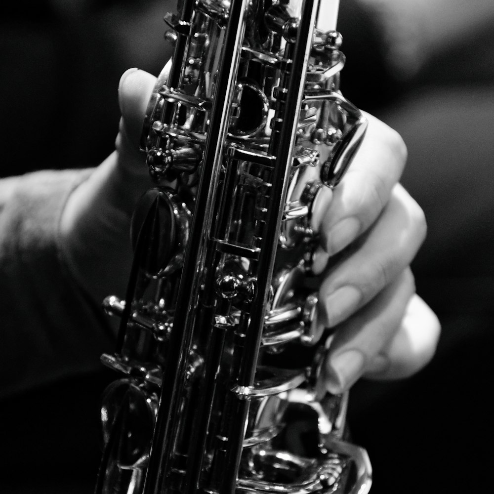 a close up of a person holding a saxophone