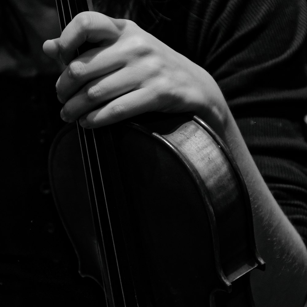 a close up of a person holding a violin