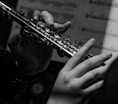 a close up of a person playing a flute