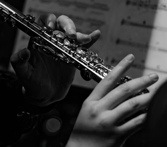 a close up of a person playing a flute