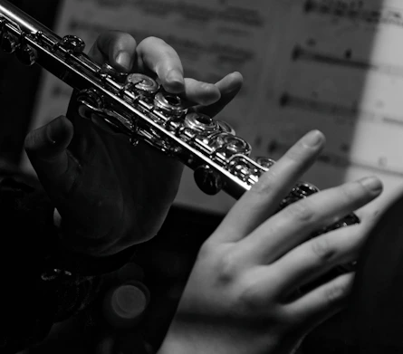 a close up of a person playing a flute