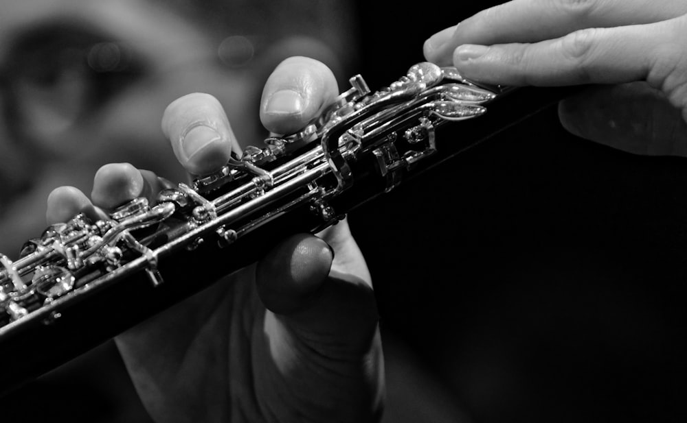 a close up of a person playing a flute