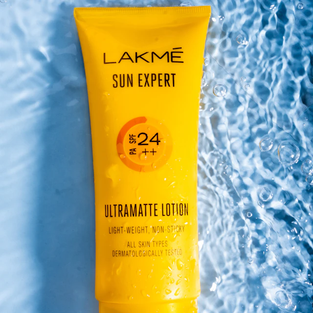 A tube of sunscreen lying on a blue surface
