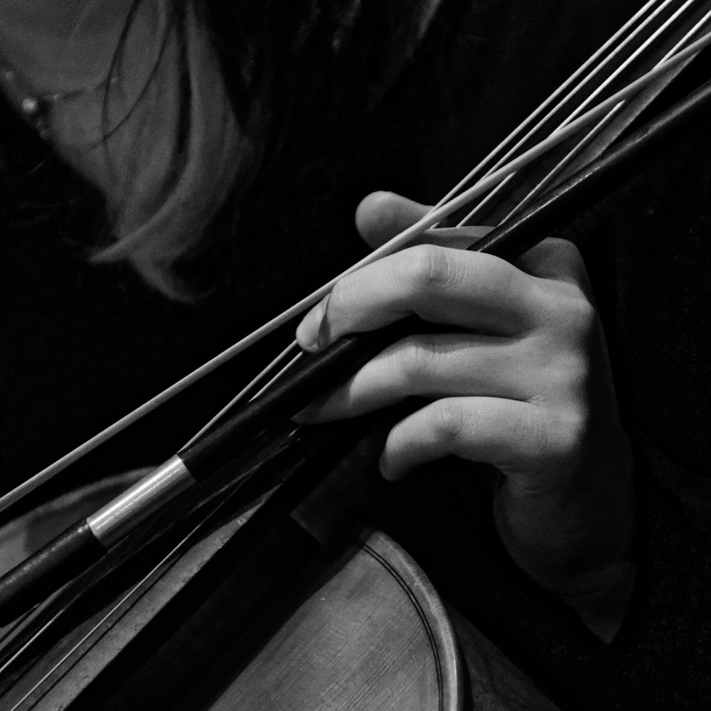 a close up of a person holding a violin