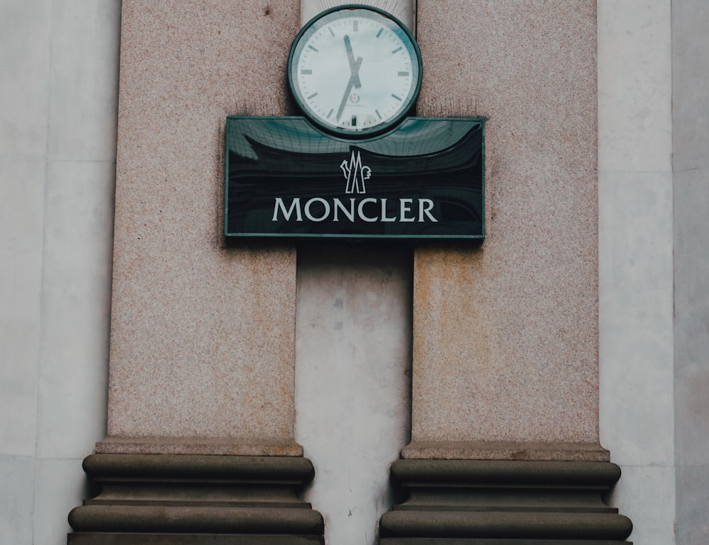 a clock mounted to the side of a building