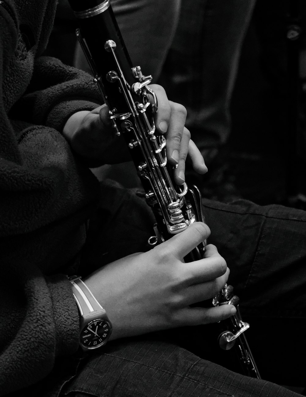 a person holding a saxophone in their hands