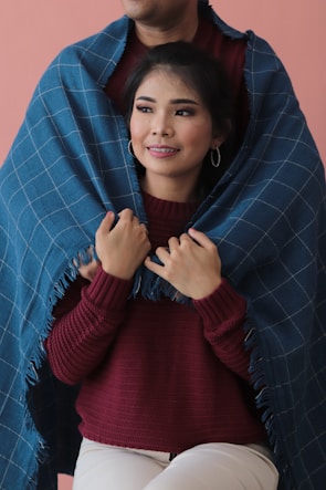 A senior woman smiling warmly while wrapped in a soft promise blanket.