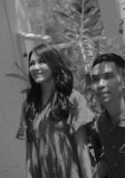 Smiling man and woman with shiny, long black hair enjoying outdoors