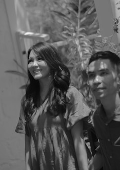 Smiling man and woman with shiny, long black hair enjoying outdoors