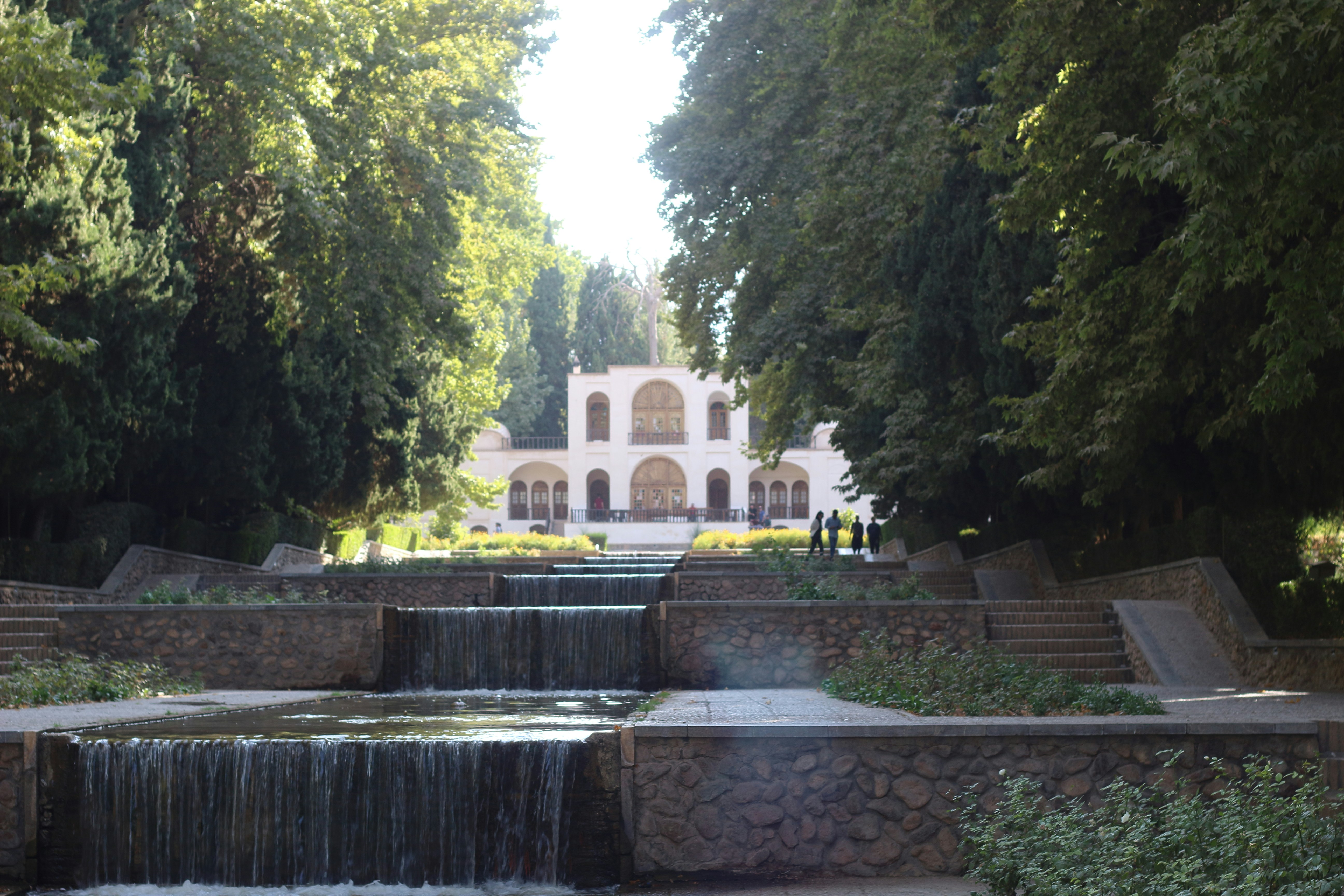 a large building with a waterfall in front of it