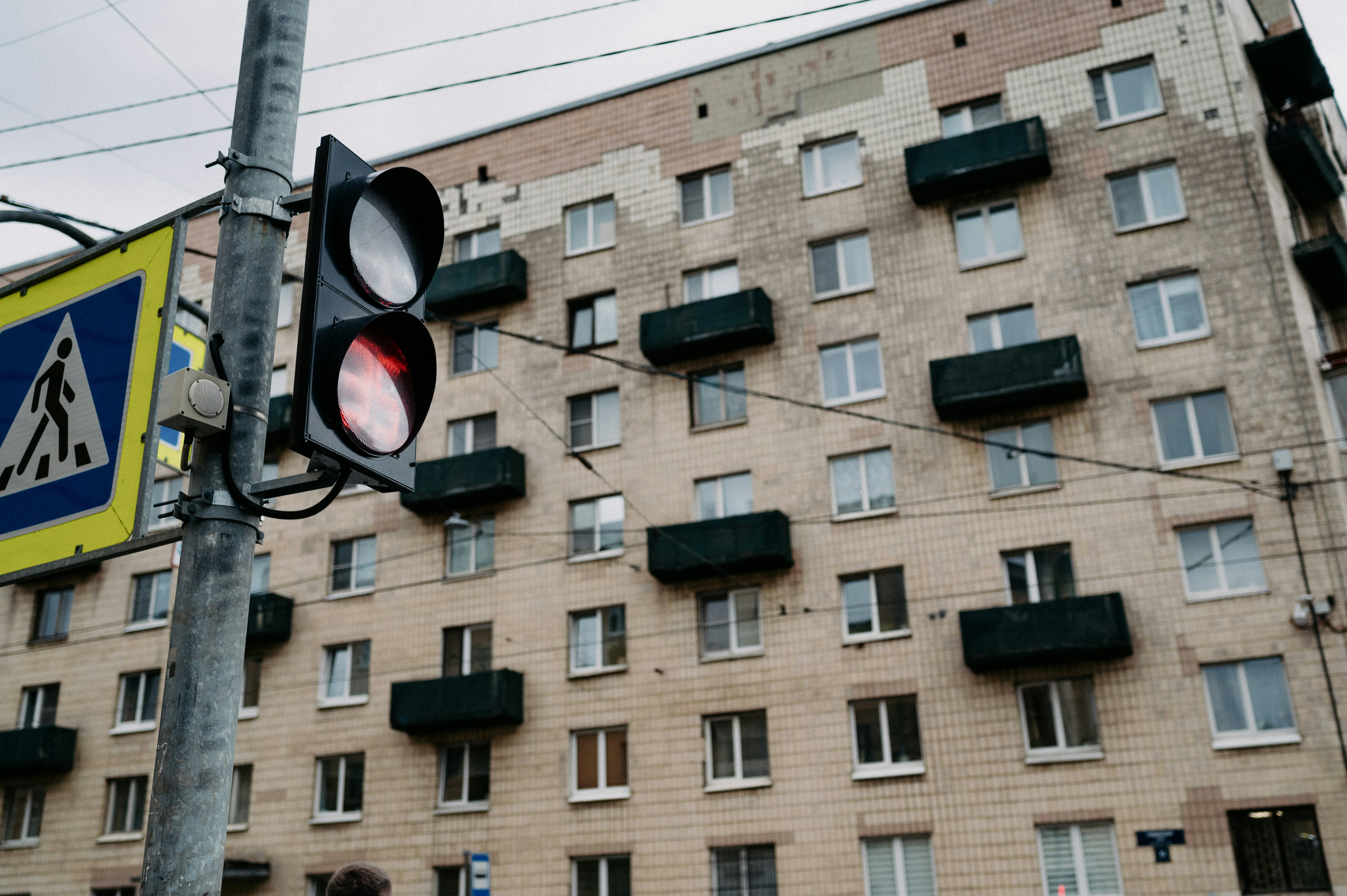 a traffic light sitting next to a tall building