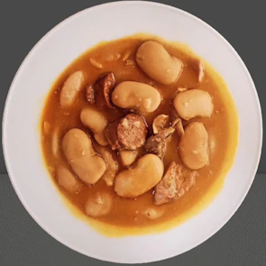 Generous plate of cocido montañés, showcasing hearty traditional Spanish stew.