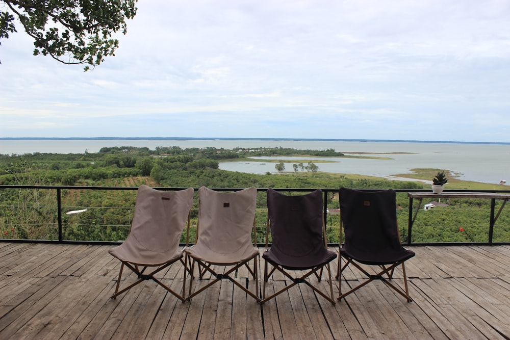 a group of chairs sitting on top of a wooden deck