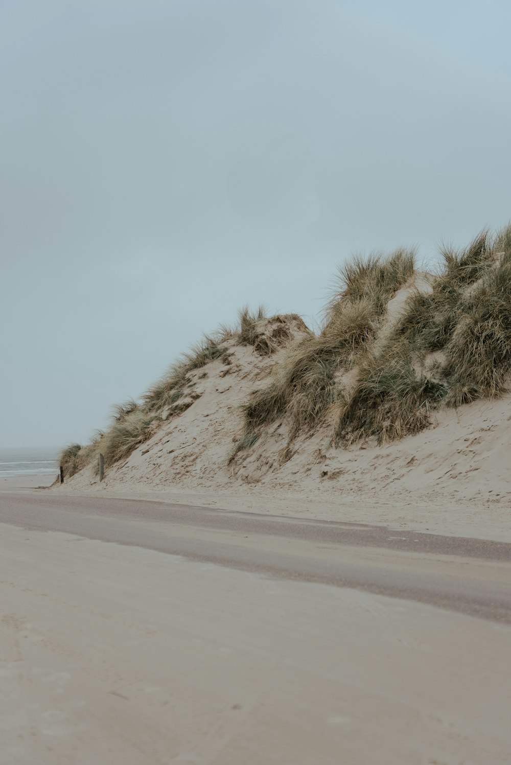 a person riding a surfboard on a sandy beach