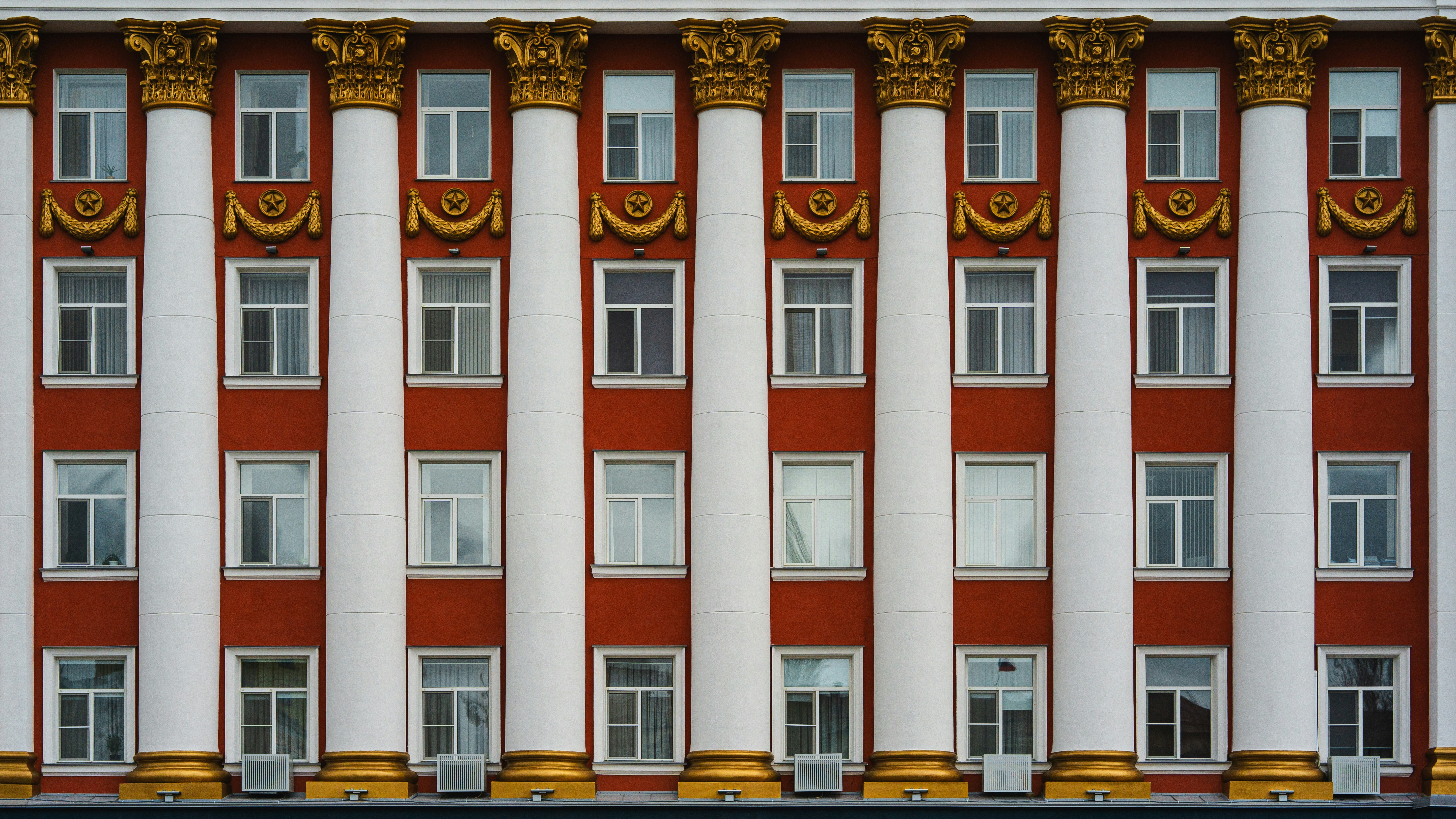 a red and white building with gold trim