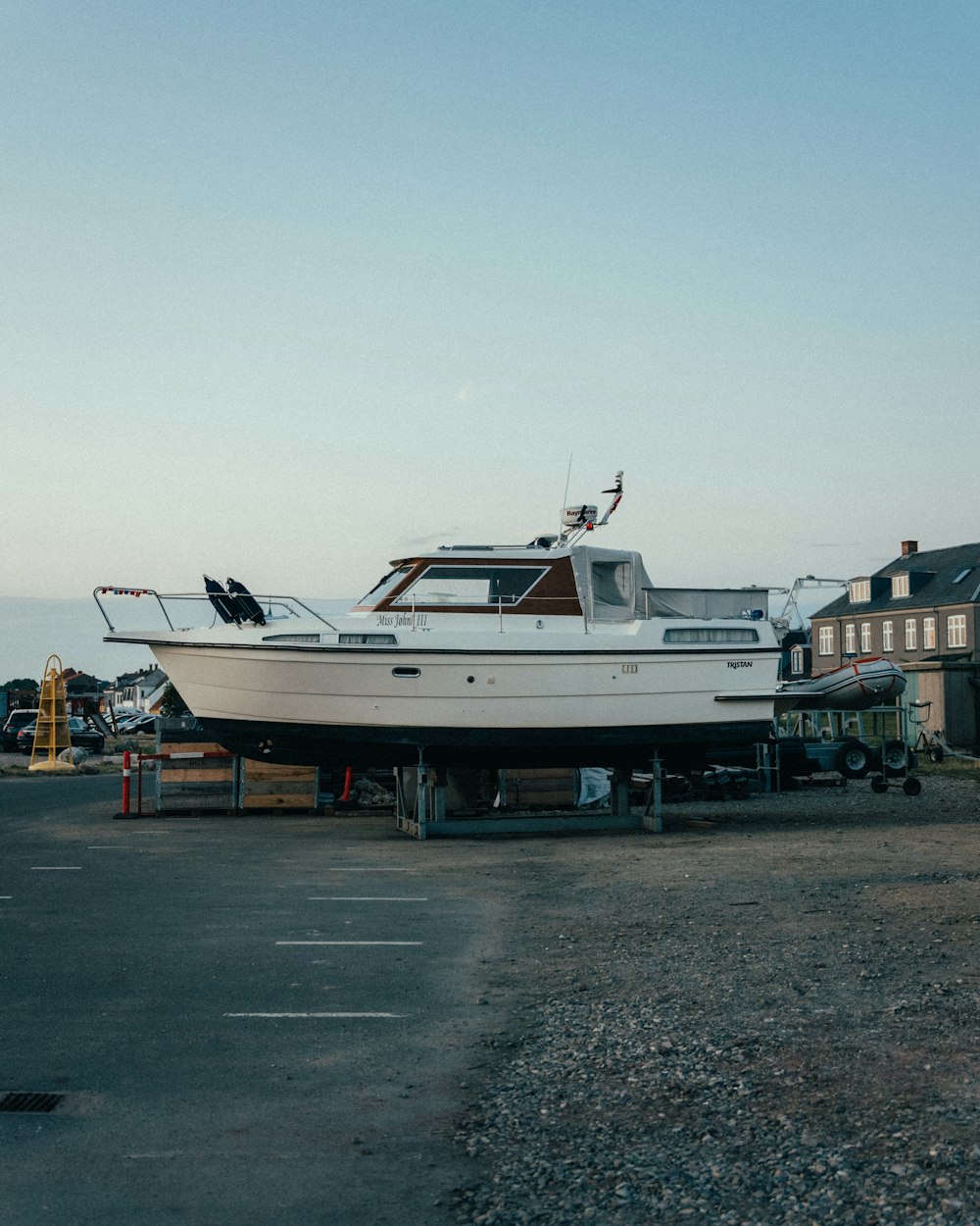 a white boat sitting on top of a trailer