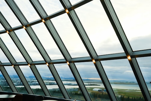 A panoramic glass wall overlooking a scenic landscape.