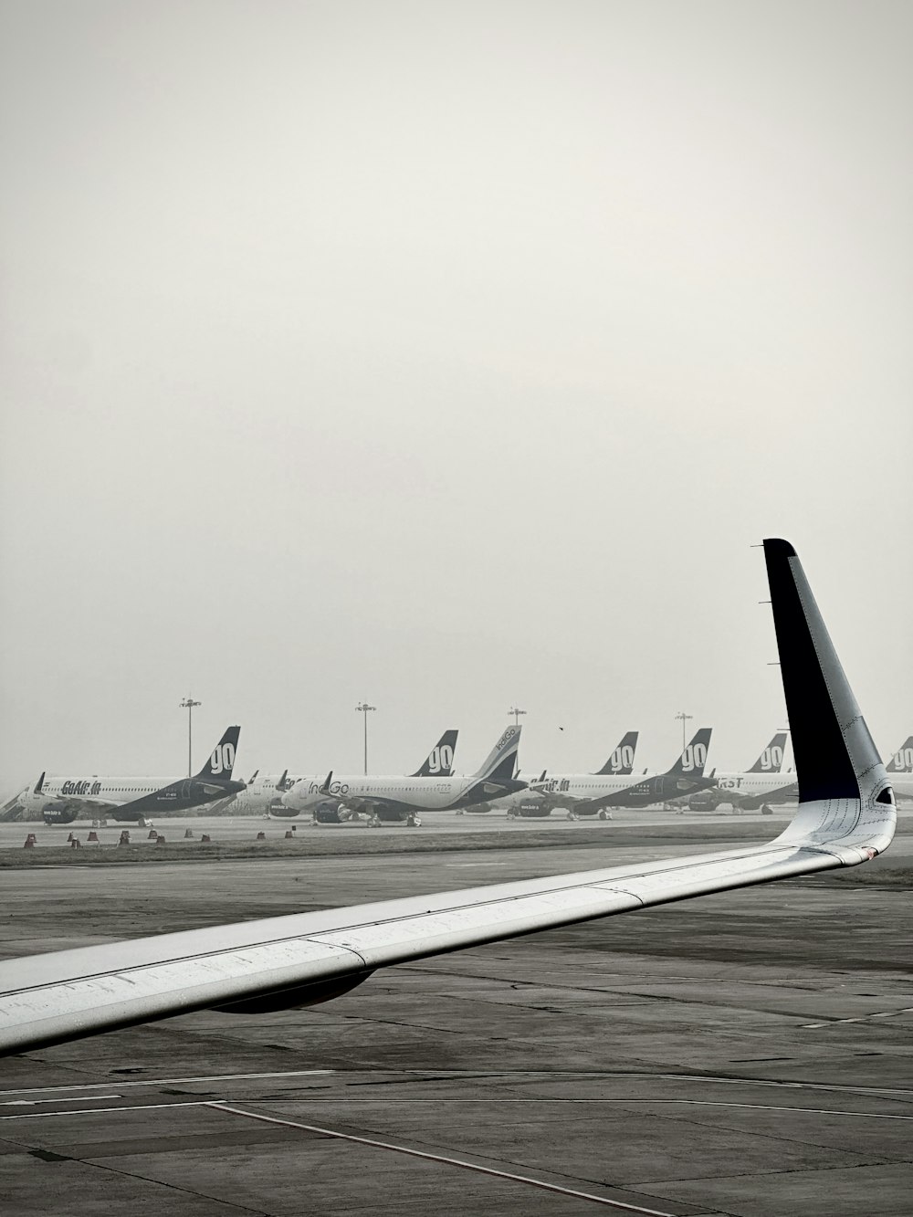 a black and white photo of airplanes on a runway
