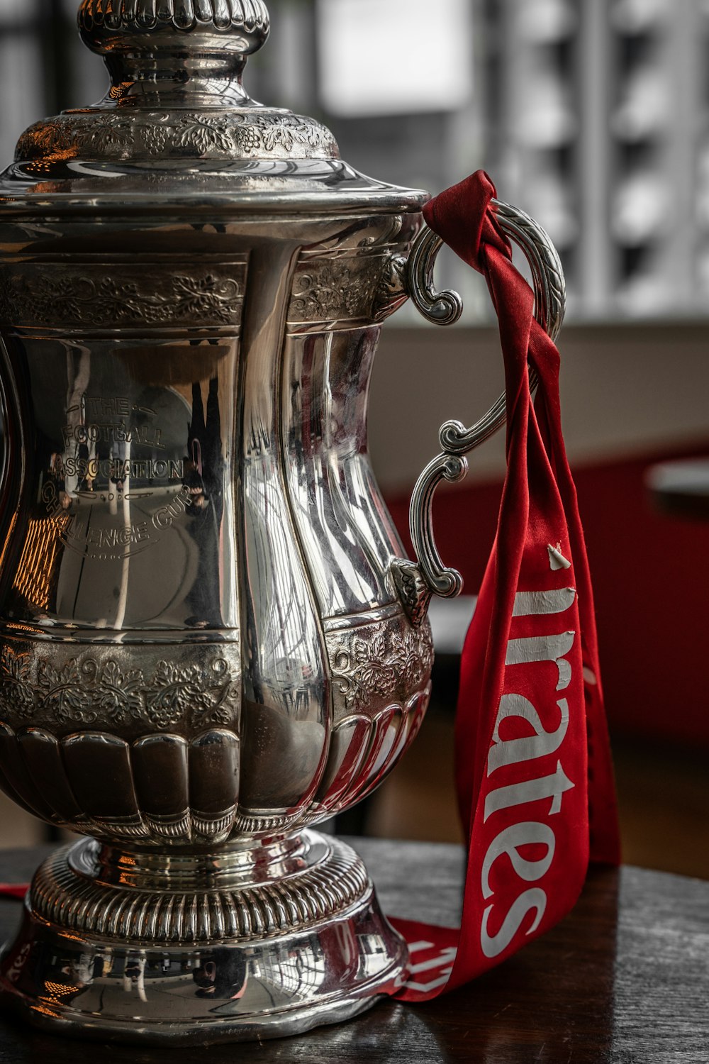 a silver trophy sitting on top of a wooden table