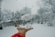 a person is throwing a snowball in the air