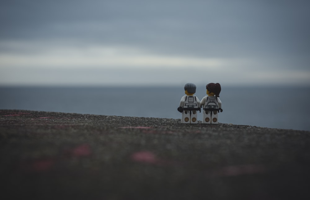 a couple of legos sitting on top of a hill