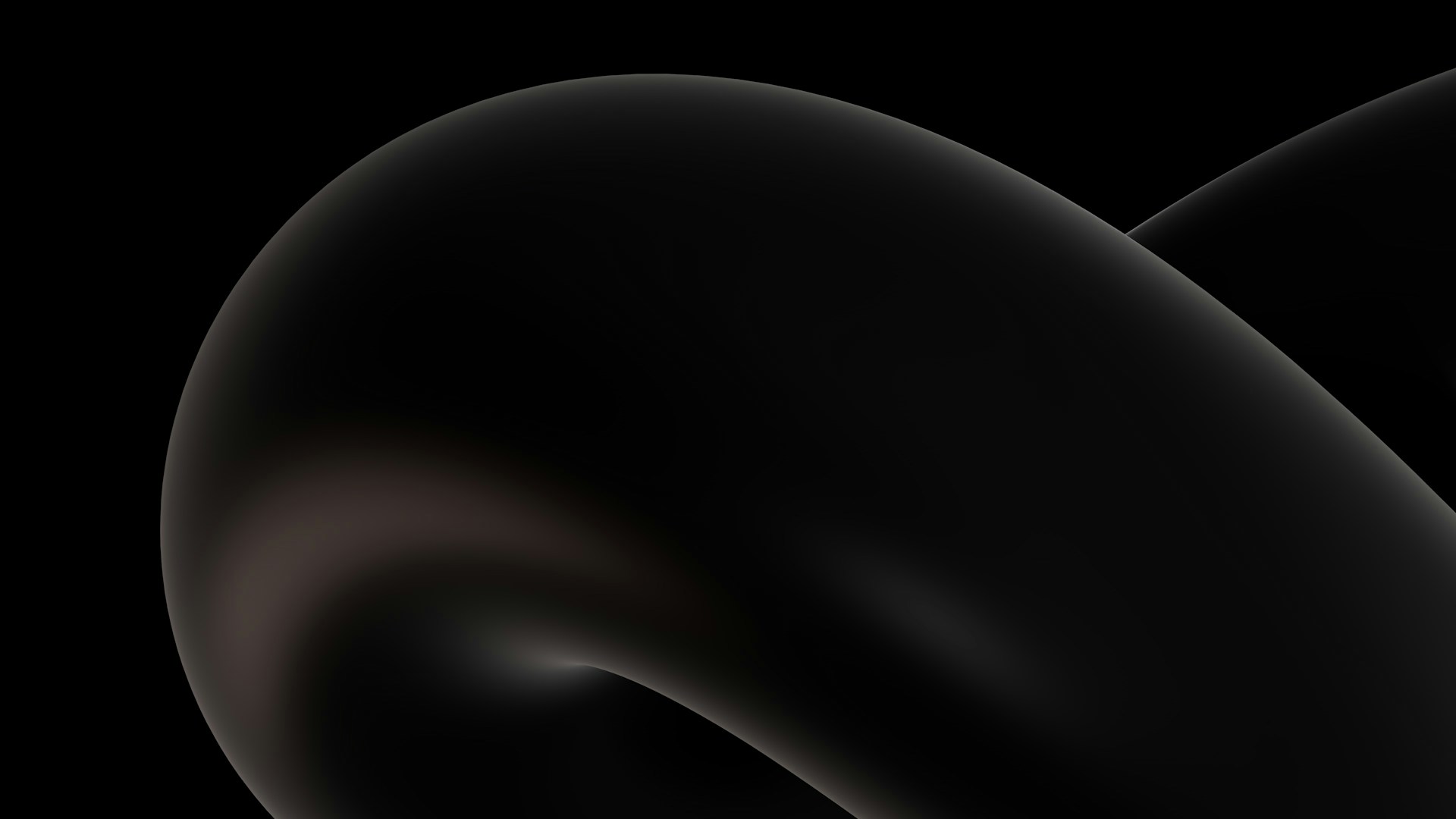 a close up of a black object on a black background