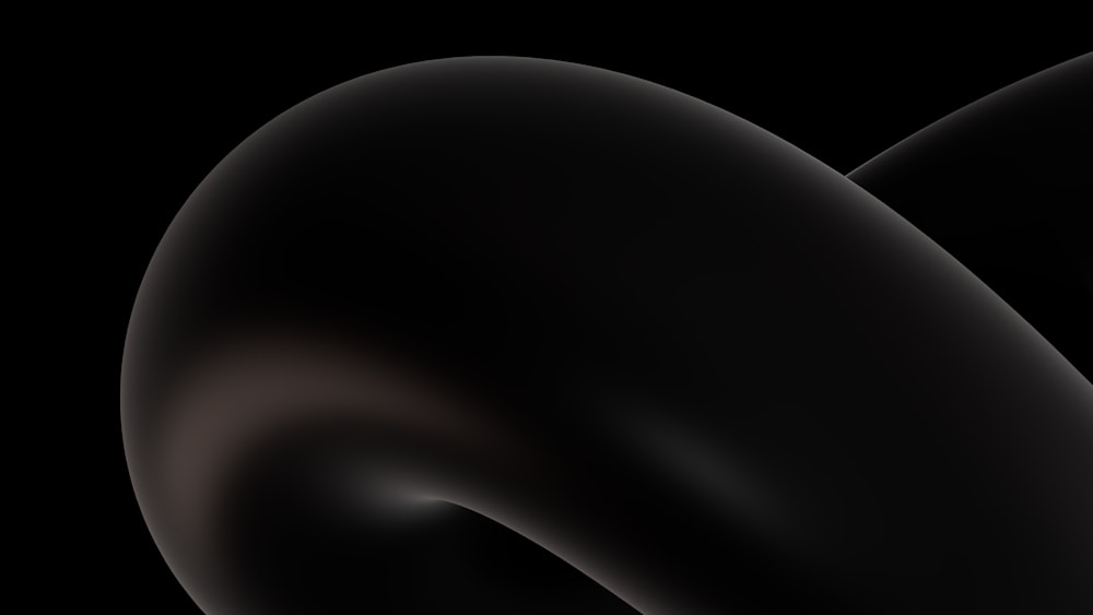 a close up of a black object on a black background