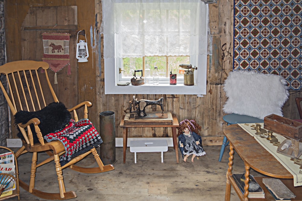 a room with a rocking chair and a sewing machine