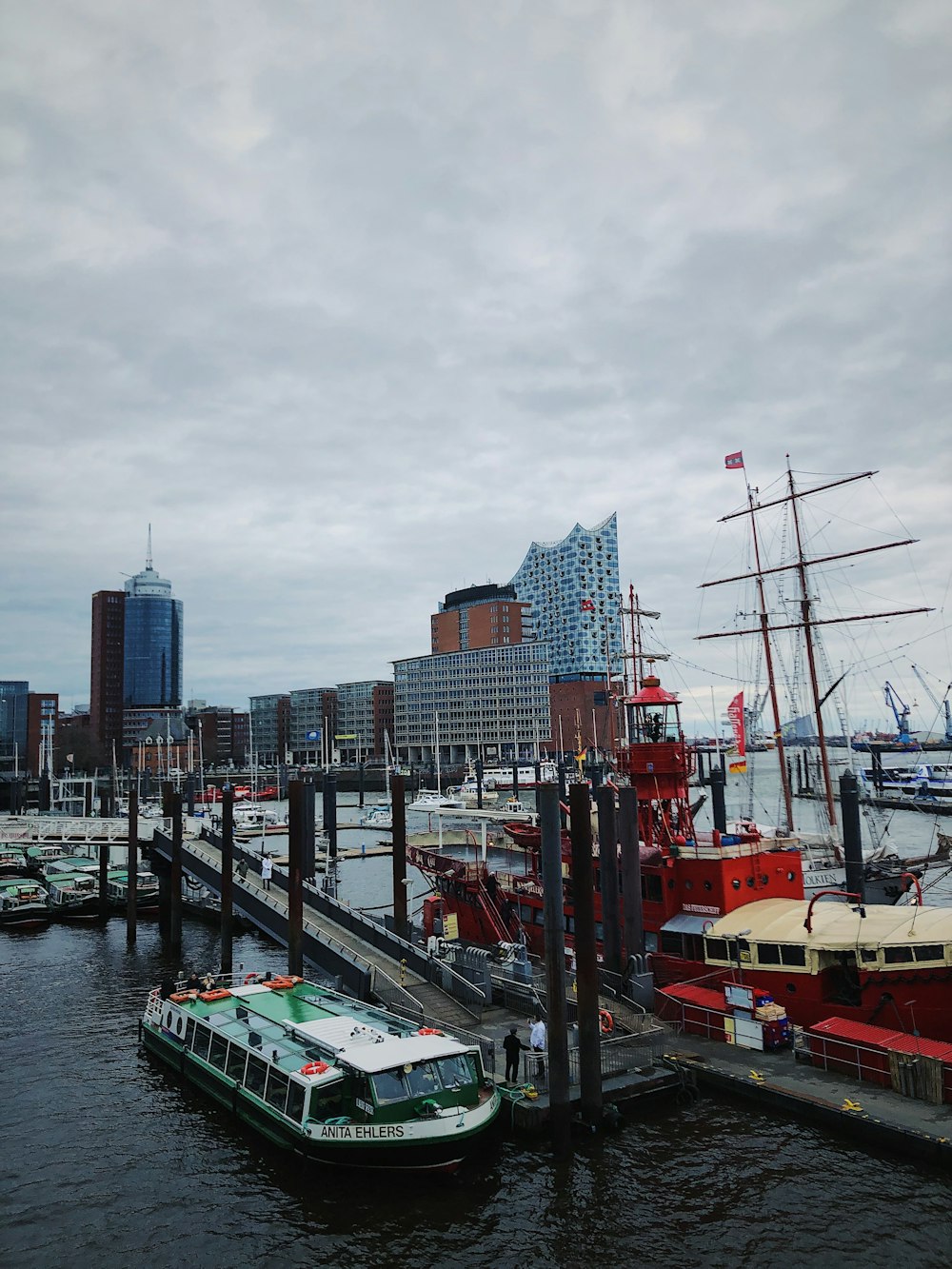 a boat is docked at a pier in a city