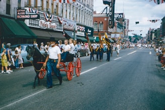 A lively parade of military bands marching through Poole with colorful flags and enthusiastic crowds.