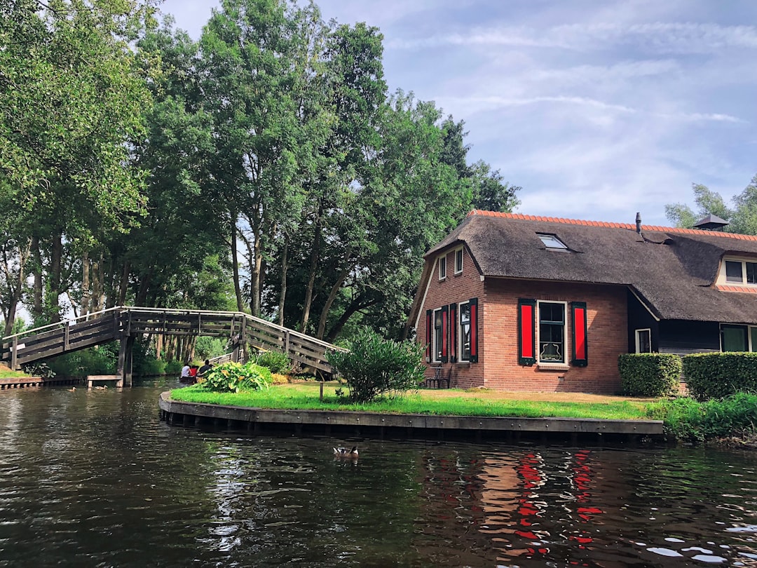 a house sitting on the edge of a body of water,