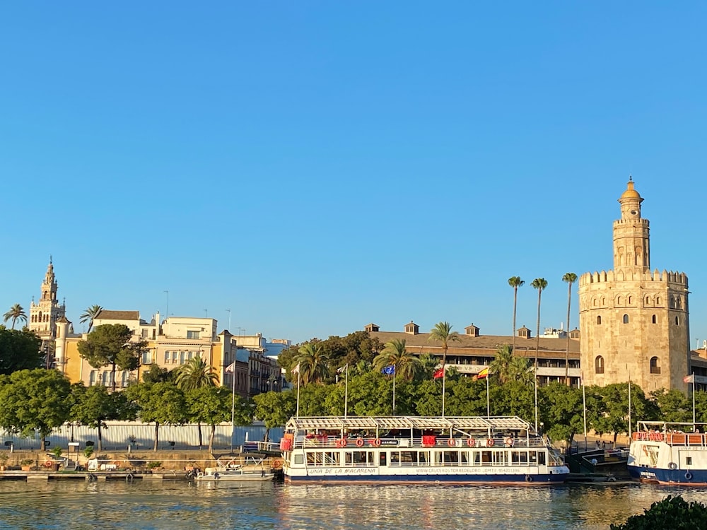 a river with a boat and a tower in the background