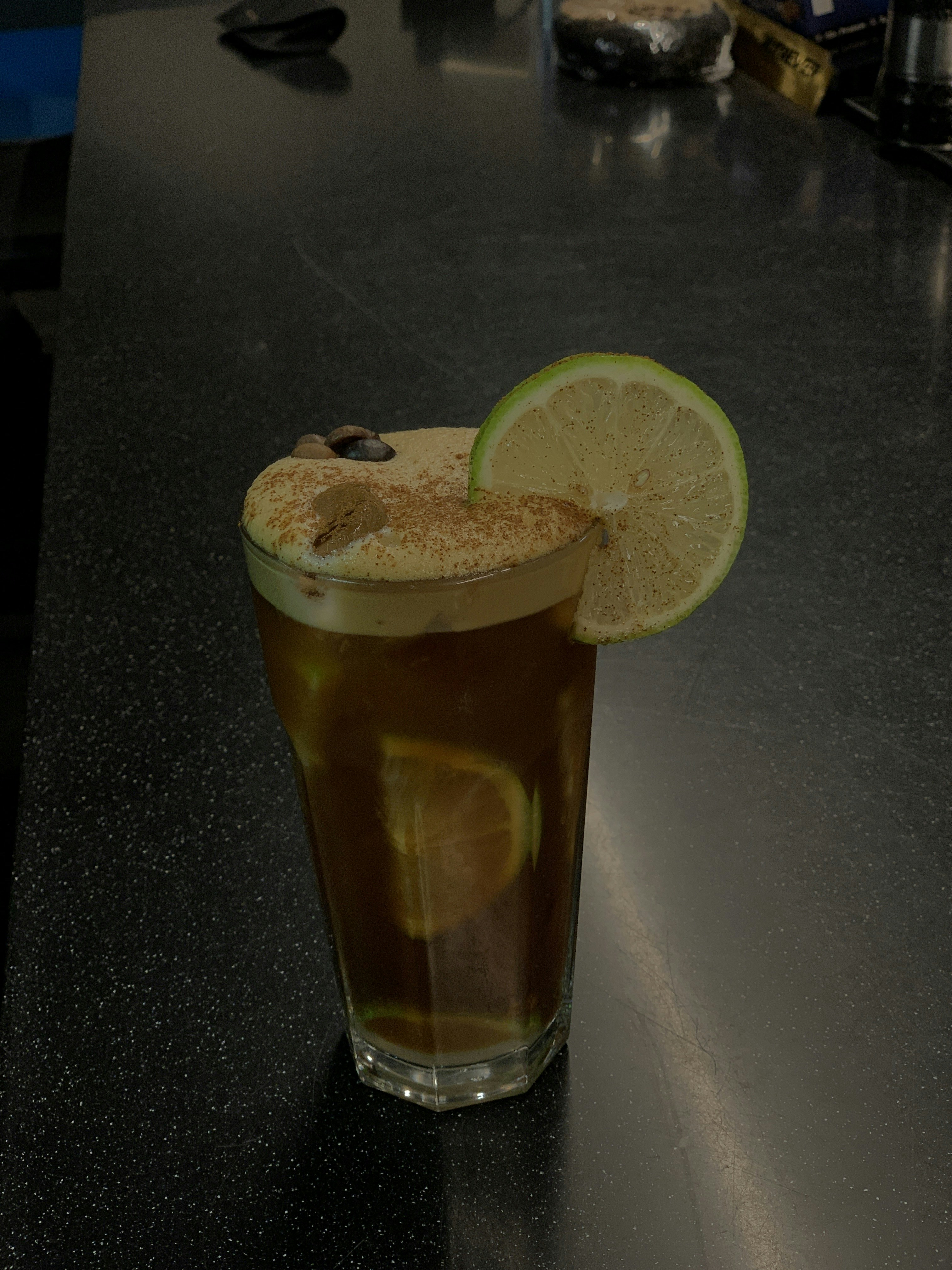 a drink with a slice of lime on top of it