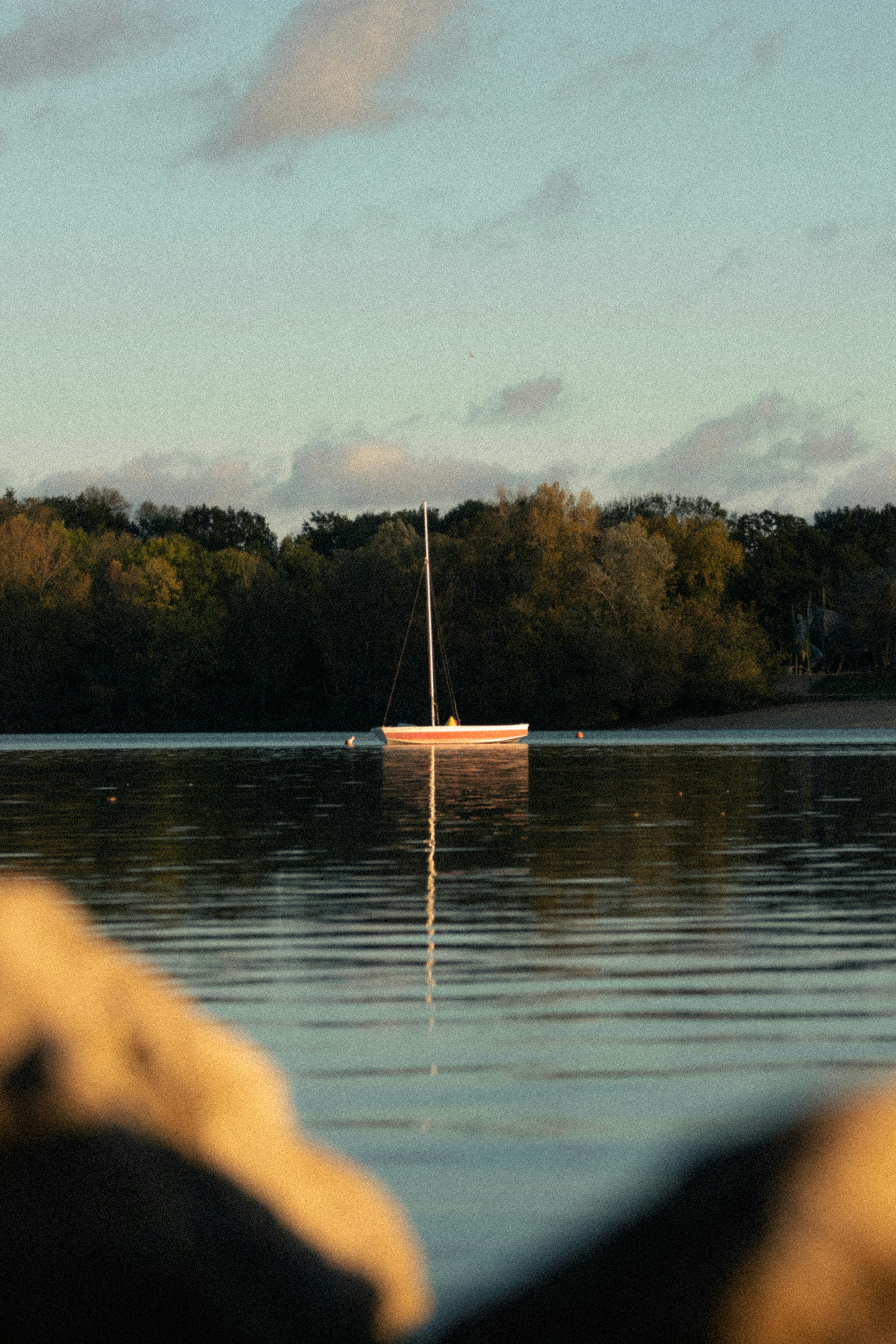 a small boat floating on top of a lake