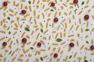 A neatly arranged flat lay of ingredients for a simple pasta dish on a soft neutral-tone background