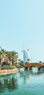 a bridge over a body of water with a building in the background