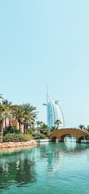 a bridge over a body of water with a building in the background