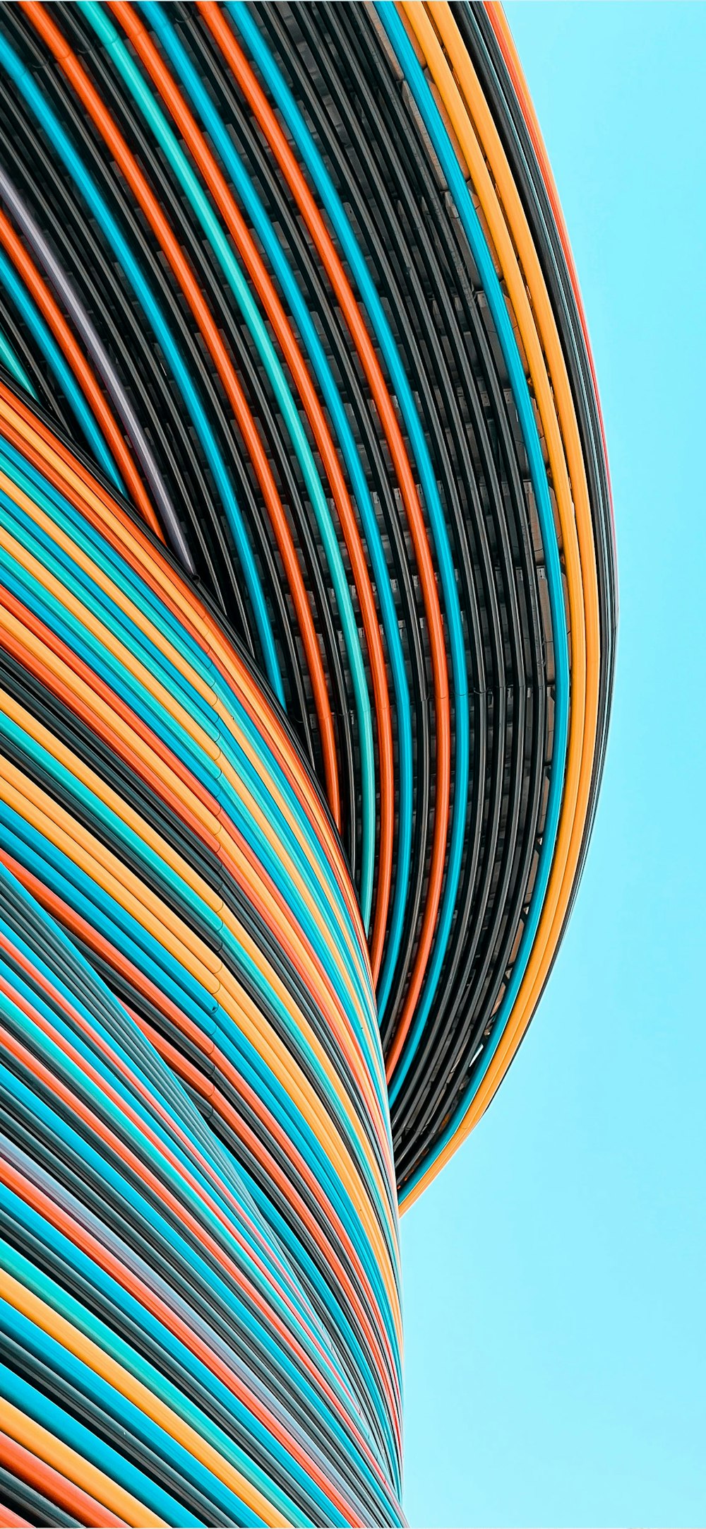 a stack of colorful wires against a blue sky