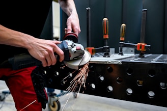 a man using a grinder on a piece of metal