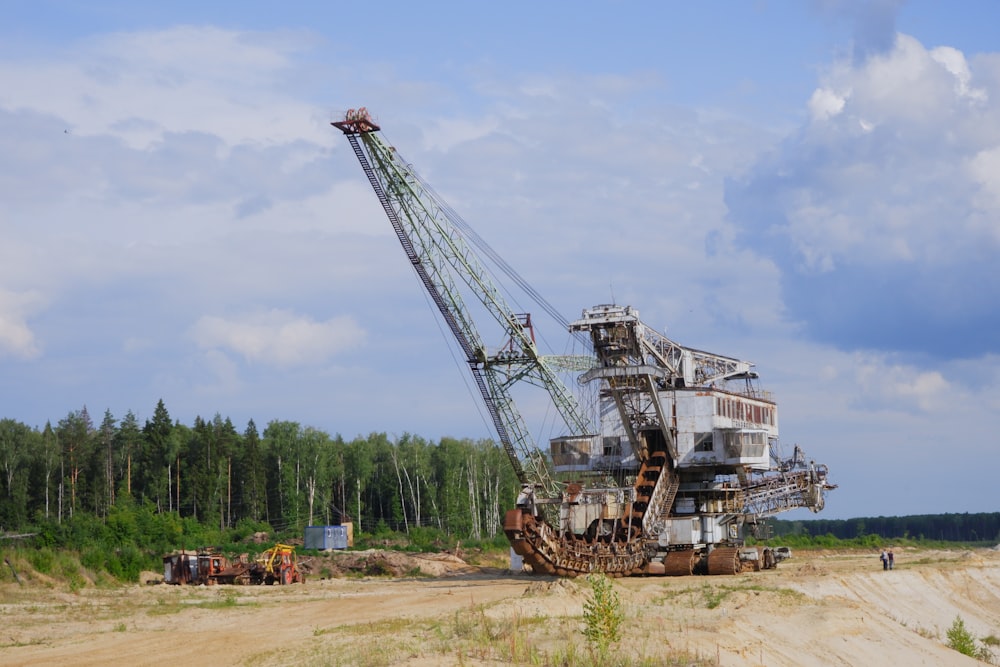 a large crane sitting on top of a dirt field