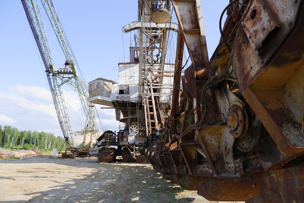 a large crane sitting on top of a dirt field