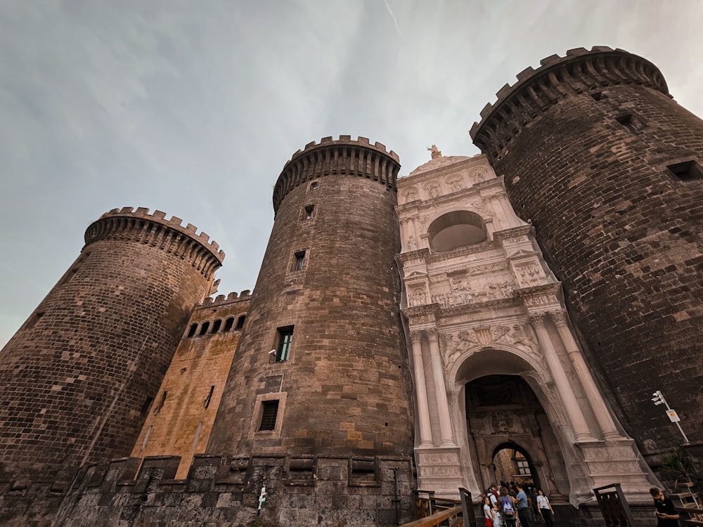 a group of people standing in front of a castle