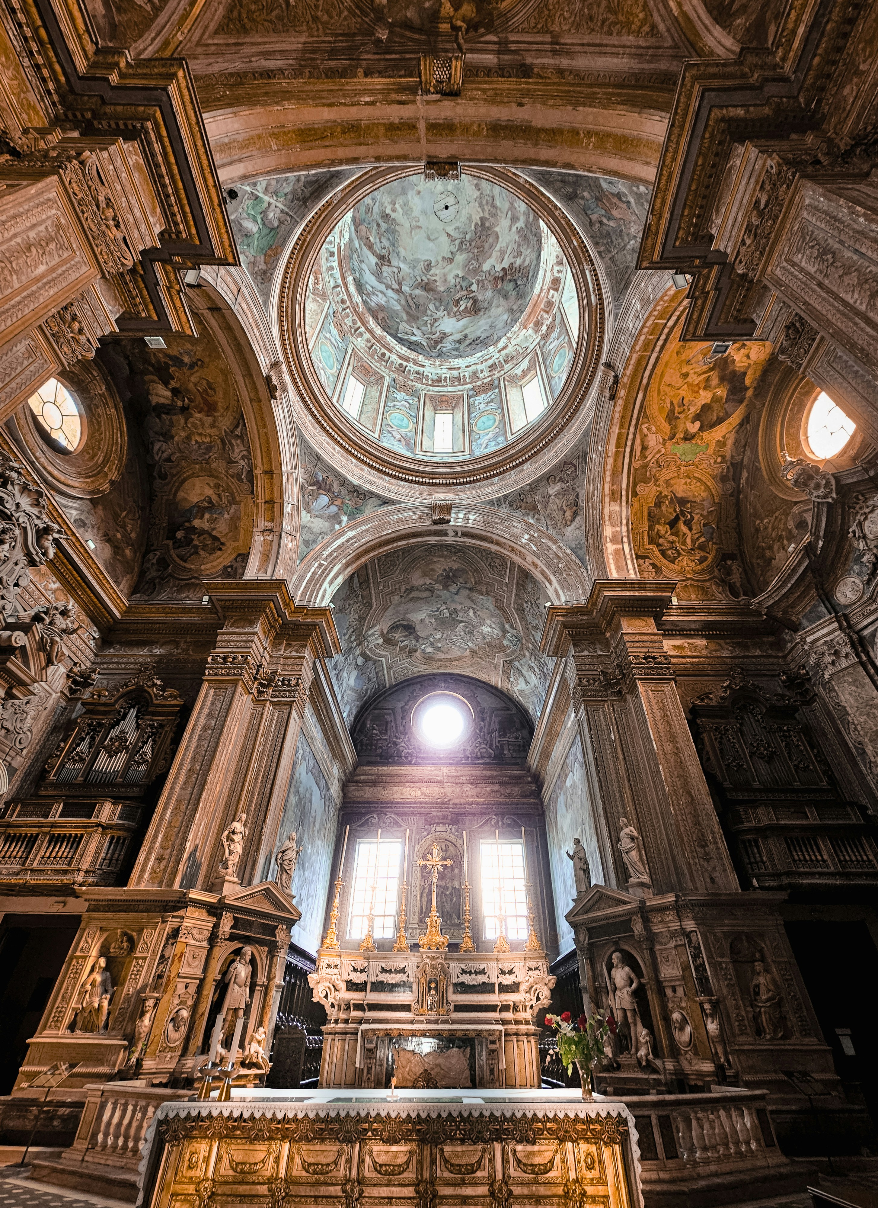 a church with a high vaulted ceiling and a stone alter