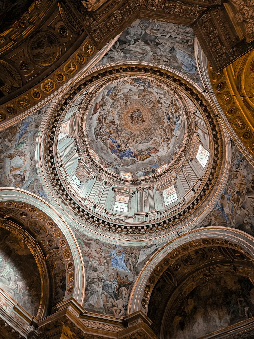 the ceiling of a building with a circular painting on it